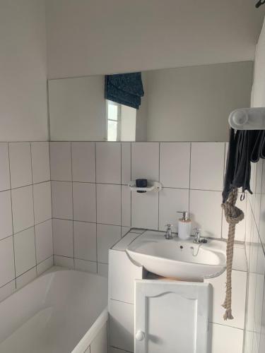 a white bathroom with a sink and a bath tub at Stormberg River Lodge in Elliot