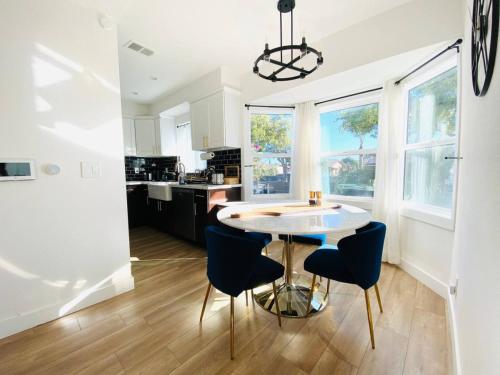 a kitchen with a table and chairs in a room at Charming 3 BR Home Near SoFi and LAX - 65th in Los Angeles