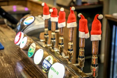 a row of champagne bottles with santa hats on them at The Pooley Bridge Inn in Pooley Bridge