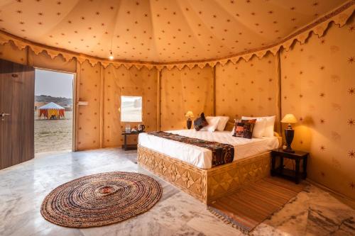 a bedroom with a bed in a tent at Sonal Desert Camp Jaisalmer in Jaisalmer