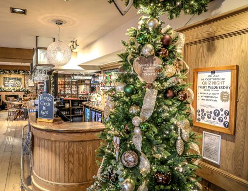 a christmas tree in the front of a store at The Pooley Bridge Inn in Pooley Bridge