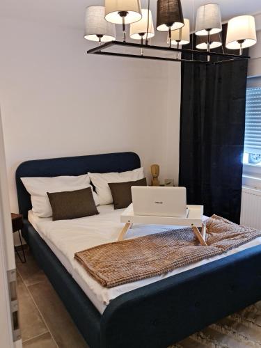 a bedroom with a bed with a laptop on it at Deluxe Apartement mit Terrasse in Duisburg