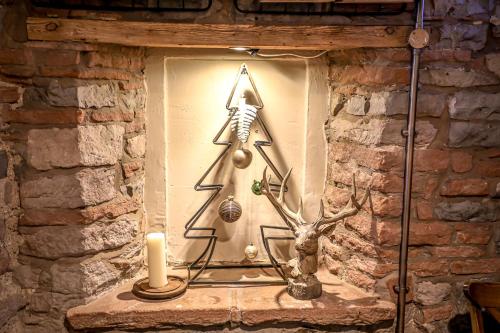 a statue of a skeleton in a window with a candle at The Pooley Bridge Inn in Pooley Bridge