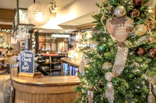 a christmas tree with a heart ornament in a store at The Pooley Bridge Inn in Pooley Bridge