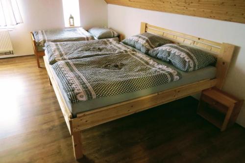 two bunk beds in a room with wooden floors at Chalupa Lízalka in Stará Červená Voda