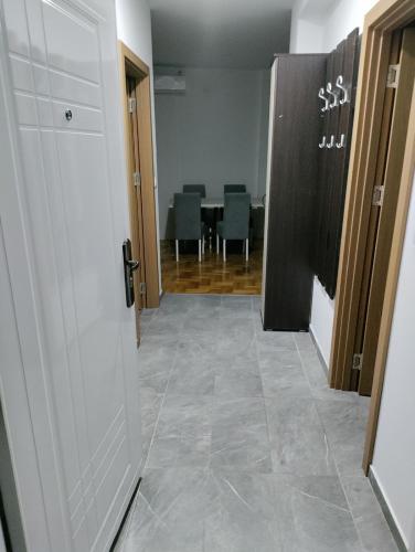 a hallway with a door and a room with a table at Cista DESETKA 2 in Požarevac