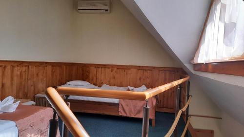 a room with a bunk bed in a attic at Atryum Hotel és Panzió in Szolnok