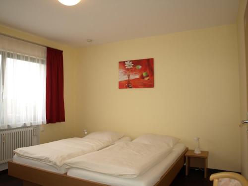 a white bed in a room with a window at Boardingroom in Filderstadt