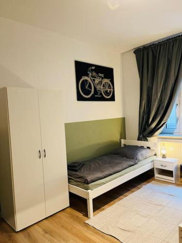 a bedroom with a bed with a motorcycle on the wall at Monteurswohnung an der Mulde in Döbeln