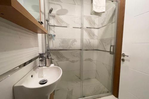 a bathroom with a glass shower and a sink at tidy 1BR apt near to nisantasi and Taksim #302 in Istanbul