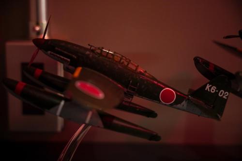 a model of a model airplane is on a stand at Red Submarine in Kure