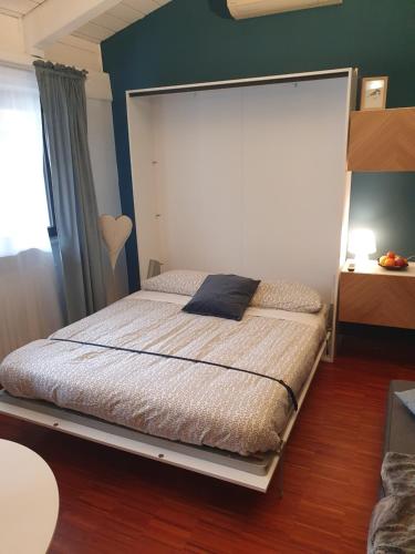 a bedroom with a bed with a large headboard at Gaia Suites in Turin