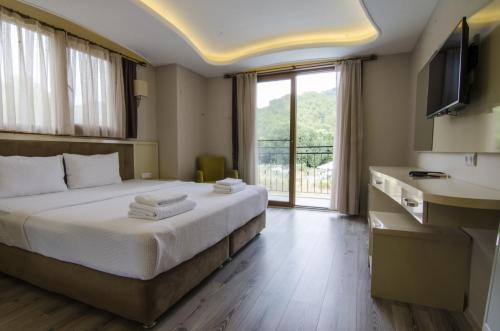 Postel nebo postele na pokoji v ubytování Funda Hotel