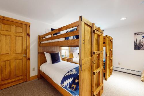 a bedroom with two bunk beds and a door at Jay Peak Village Home 375 in Jay