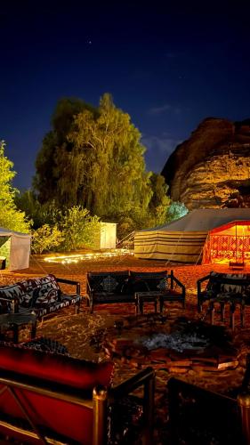 a group of benches and a tent at night at Almansour farm in AlUla