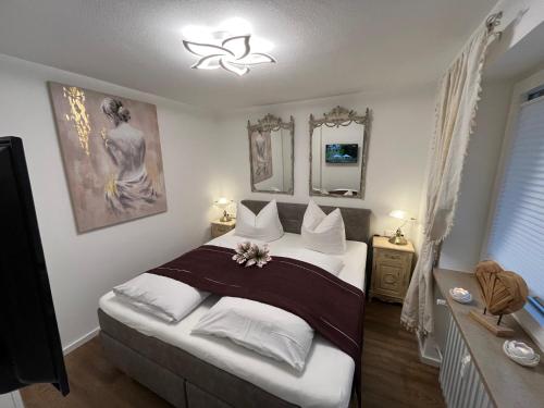 a bedroom with a large bed with white pillows at Alpenflair Ferienwohnungen Whg 236 in Oberstdorf
