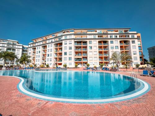 a large swimming pool in front of a building at Attico 512 - Golf del Sur in San Miguel de Abona