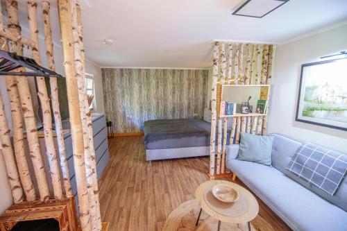 a living room with a couch and a bed at Ferienhaus Paula in Leipe