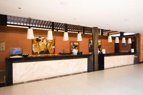 a lobby of a hotel with a reception counter at Vila Galé Resort Marés - All Inclusive in Guarajuba