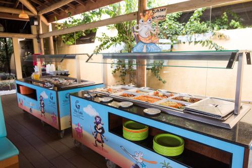 a buffet line with food in a restaurant at Vila Galé Resort Marés - All Inclusive in Guarajuba