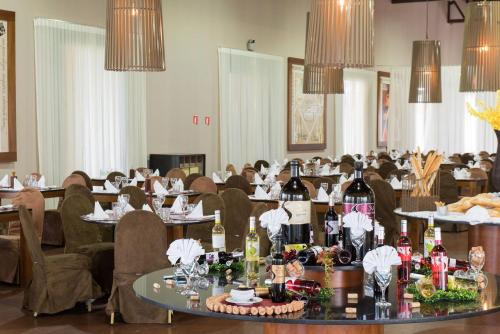 a dining room with tables with bottles of wine at Vila Galé Resort Marés - All Inclusive in Guarajuba
