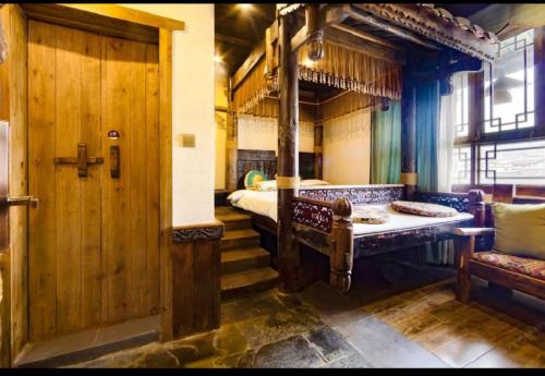 a train room with a bed and a door at Butterfly Flowers Inn in Zhangjiajie