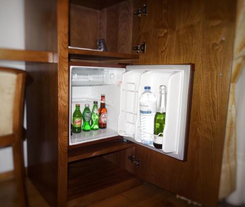 an open refrigerator filled with bottles of alcohol at Hotel Estalagem Turismo in Bragança