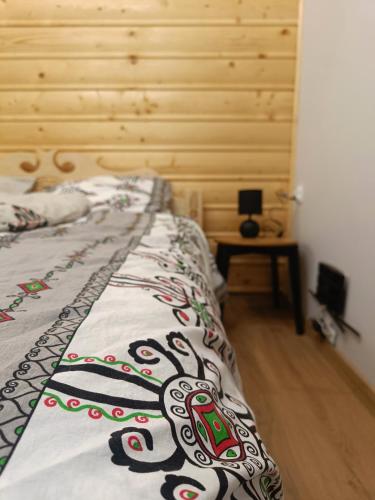 a bedroom with a bed with a blanket on it at Apartament Oravski in Suchá Hora