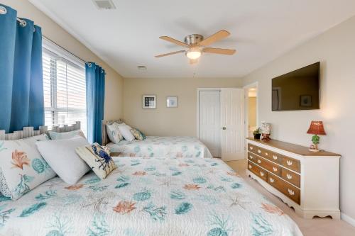 a bedroom with two beds and a ceiling fan at North Myrtle Beach Condo Community Pool and Hot Tub in Myrtle Beach
