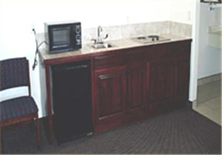 a kitchen with a sink and a microwave at Texas Inn & Suites in La Joya
