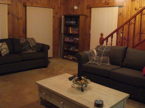 a living room with a couch and a coffee table at The Retreat on Matthew in Batehaven