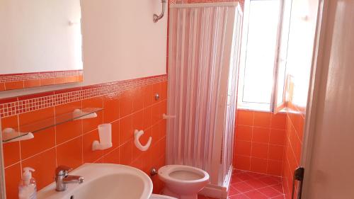 y baño con aseo, lavabo y ducha. en SanMarco Holiday Home en Ascea