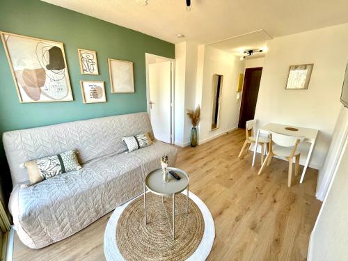 a living room with a couch and a table at Bel appartement Saint Raphaël in Saint-Raphaël