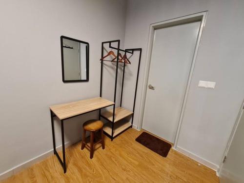a room with a table and a mirror and a stool at Luxury Tangerine Suites KLIA in Sepang