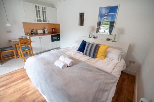 a bedroom with a large bed with two towels on it at Kilpatrick Glebe in Crossabeg