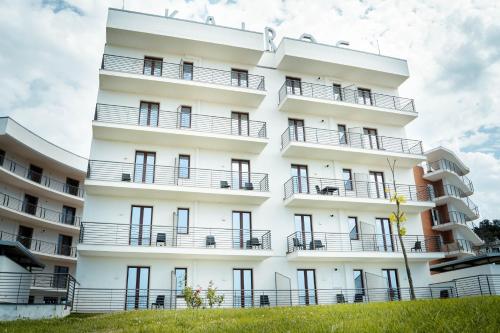 an apartment building with balconies on a hill at Kairos Hotel in Pianura
