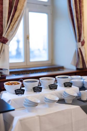 a table with bowls of food on a table at Grandhotel Zvon in České Budějovice