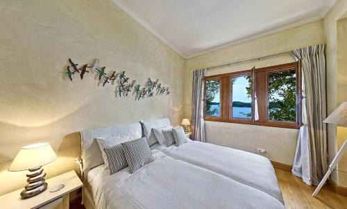 Posteľ alebo postele v izbe v ubytovaní Villa Veneziano Suites & Villa