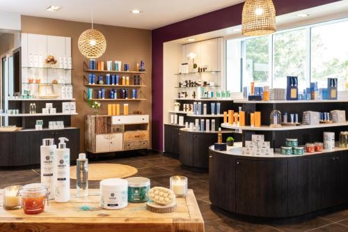 a store with a table and shelves of books at Résidence Valdys Thalasso & Spa - les Pins in Saint-Jean-de-Monts