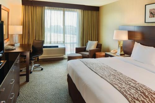 a hotel room with a bed and a desk and a room at DoubleTree by Hilton Hotel Boston Bayside in Boston