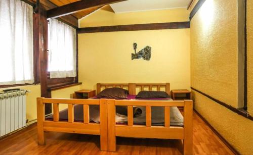 a bedroom with a wooden bed in a room at Pansion Sebilj in Sarajevo