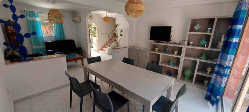 a living room with a dining room table and chairs at salam in Agadir