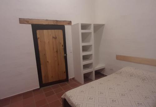 a small room with a door and a shelf at Casa San Sebastian in Guasca