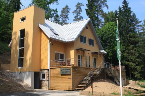 a house with a metal roof on top of it at Tehvandi Puhkemaja in Otepää