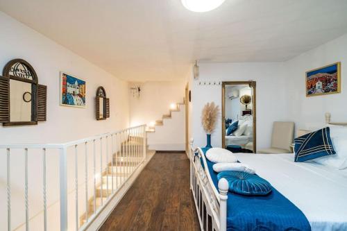 a bedroom with a large bed and a staircase at Plaza Royal in the centre in Dubrovnik