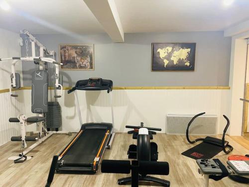 a gym with cardio equipment in a room at L’appart classé 4* in Longeville-sur-Mer