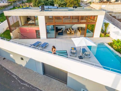 an aerial view of a house with a swimming pool at Lake House in Calheta