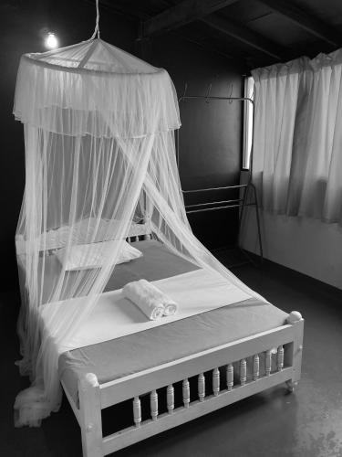 a bed with a canopy in a room at Railway Hostel in Matara
