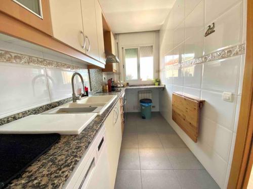 a kitchen with a sink and a counter top at Big Family Terrassa Parking and noise free in Terrassa