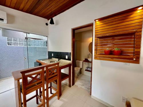 a kitchen with a sink and a toilet in a room at Pousada Ilha do Campeche in Florianópolis